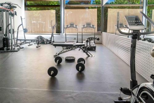 a gym with several chairs and weights on the floor at Hotel Planas in Salou