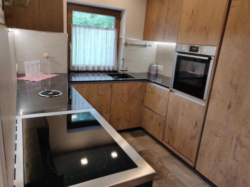 a kitchen with wooden cabinets and a counter top at Innertrein in Cadipietra