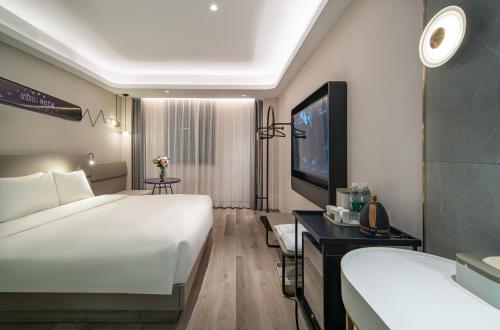 Postel nebo postele na pokoji v ubytování Atour Light Hotel Shanghai Xujiahui Jiaotong University