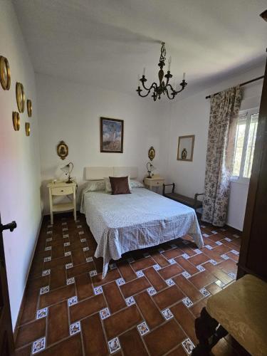 a bedroom with a bed and a wooden floor at El Arrabal de la Barrosa in Chiclana de la Frontera