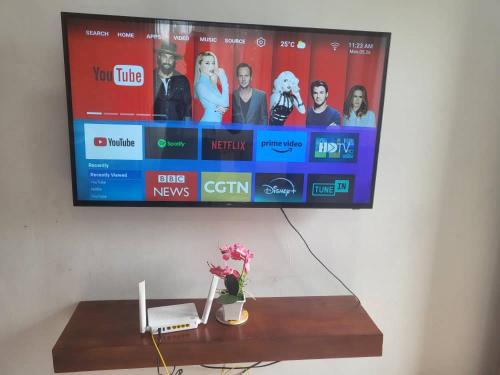 a flat screen tv hanging on a wall at Bieni Homes in Nkunjila