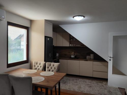 a kitchen and dining room with a table and chairs at Butmir house-Sarajevo in Ivišovo Greblje