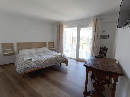 a bedroom with a bed and a window and a chair at B&b Il Leccio in Subiaco