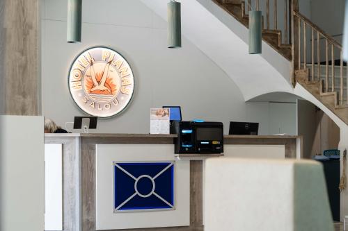 a clock on the wall next to a staircase at Hotel Planas in Salou