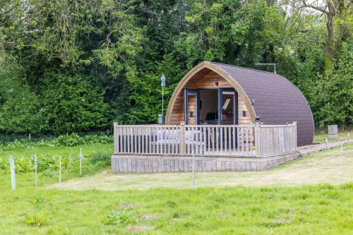 a small cabin in the middle of a field at Ashberry Glamping Pod in York