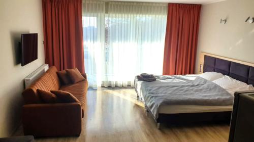 En eller flere senge i et værelse på Dominikana Apartament 41b