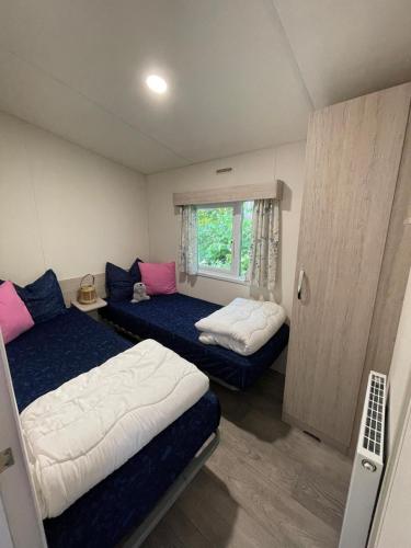 a small room with two beds and a window at Chalet JT08 in Renesse in Renesse