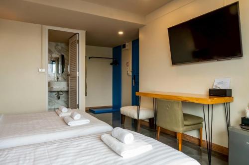 Ένα ή περισσότερα κρεβάτια σε δωμάτιο στο Ployburi Boutique Hotel