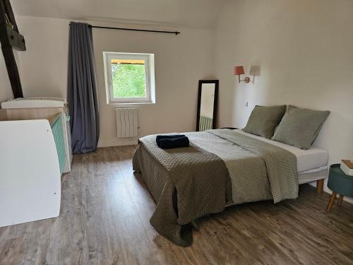 a bedroom with a large bed and a window at Chambres d'hôtes Provins in Poigny