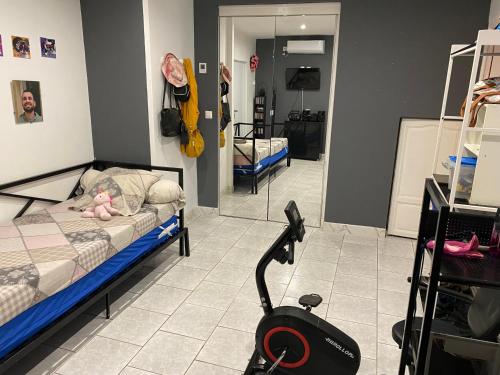 a room with a bed and a treadmill at Appart 2 pièces in Canaules-et-Argentières