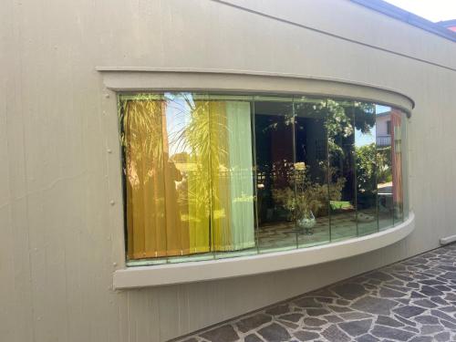 a window on a building with curtains in it at Villa Rita Guest House Torvaianica in Torvaianica