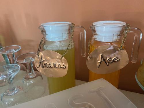 two glasses and two jars of beer on a table at Villa Rita Guest House Torvaianica in Torvaianica