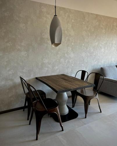 a dining room with a wooden table and chairs at Lake Hill Karkonosze Apartments in Sosnówka