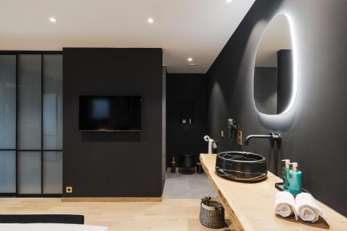 a bathroom with a sink and a mirror at Suite Zen By M in Francorchamps