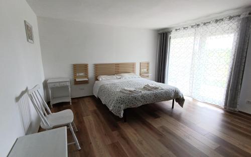a bedroom with a bed and a wooden floor at B&b Il Leccio in Subiaco