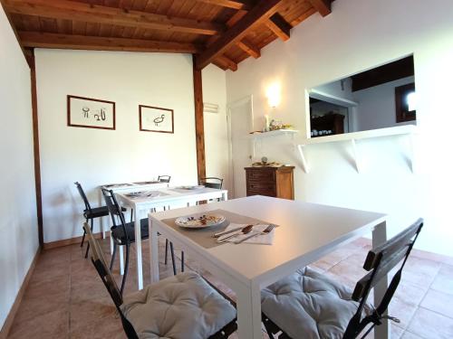 a dining room with a white table and chairs at B&b Il Leccio in Subiaco
