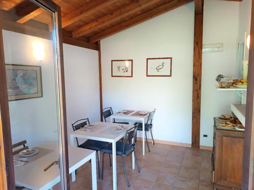 a dining room with two tables and chairs at B&b Il Leccio in Subiaco