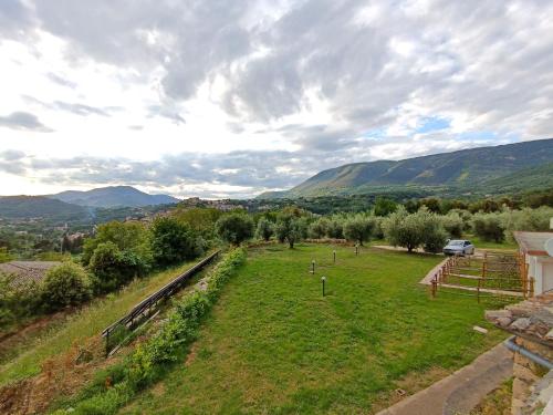 an aerial view of a field with mountains in the background at B&b Il Leccio in Subiaco