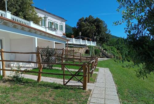 a group of wooden benches in front of a house at B&b Il Leccio in Subiaco