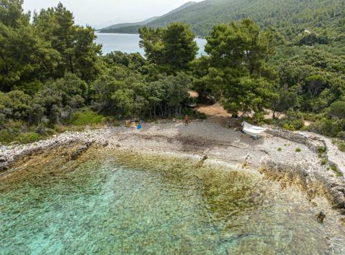an aerial view of a beach with trees and water at Stone House Blaca in Blato