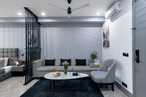 a living room with a couch and a table at BedChambers Luxurious Serviced Apartment in Gurgaon in Gurgaon