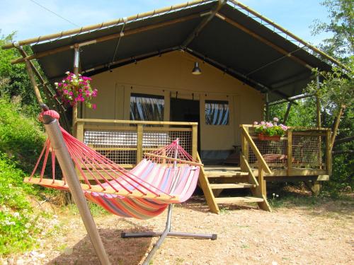 a hammock in front of a house at Lodge Holidays - Casa Tartufo in Radicosa