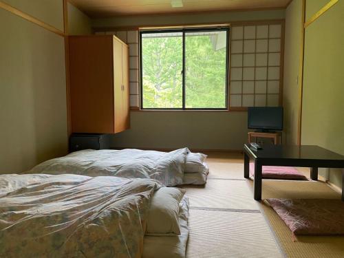 Postel nebo postele na pokoji v ubytování 四季彩の宿やまぶき