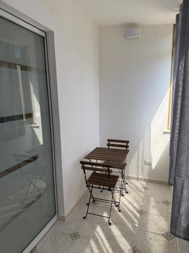 two chairs and a table in a room at Oreto Apartment in Palermo