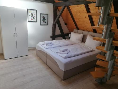 a bedroom with a bed and a wooden ceiling at Trobischhof in Dresden