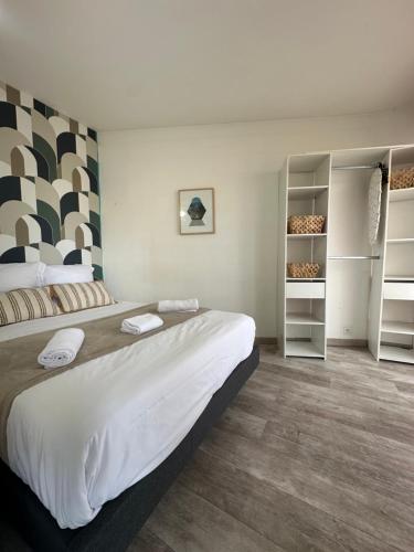 - une chambre avec un grand lit et des étagères dans l'établissement La Clé - Balcon - Climatisation - Wifi - Port - Gare, à Toulon