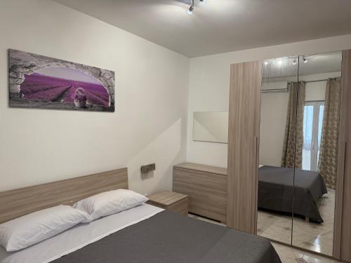 a bedroom with a bed and a mirror at Oreto Apartment in Palermo