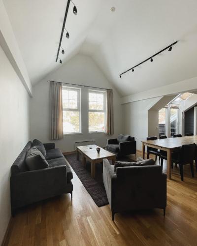 a living room with black couches and a table at Hovdestøylen Apartments in Hovden