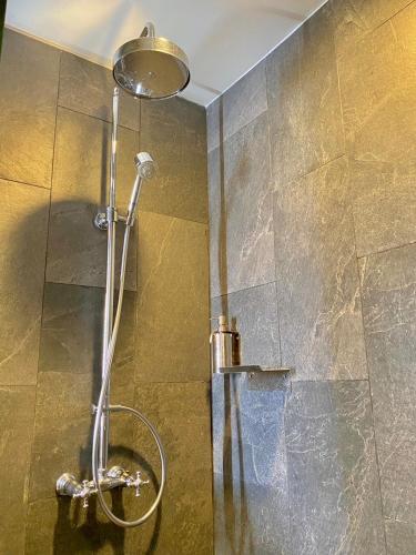 a shower in a bathroom with a glass wall at Mybed Gold Chonburi in Ban Lang Khao