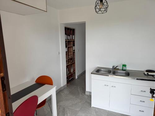 a kitchen with a sink and a counter and a sink at D ici tout commence in Fournet-Blancheroche