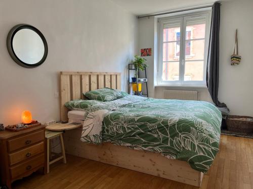 une chambre avec un lit, un miroir et une fenêtre dans l'établissement Cozy bright apartment Croix Roussien, à Lyon