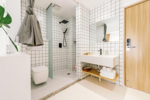 a bathroom with a sink and a toilet at Guan Erjie Boutique Hotel (Huimin Street of Xi'an Bell Tower ) in Xi'an