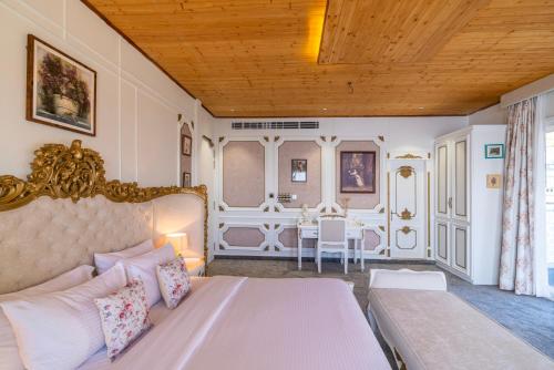 a bedroom with a large bed and a table at The English Country House in Mussoorie