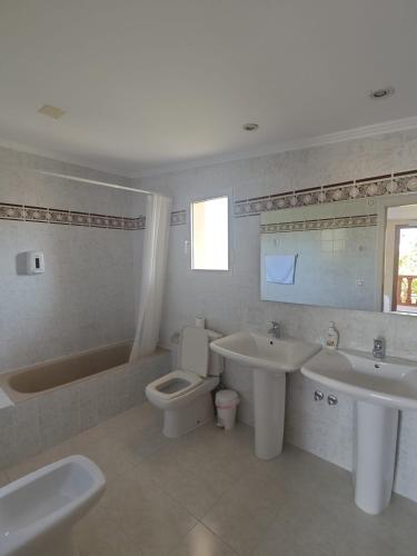 a bathroom with a tub and a toilet and a sink at Alojamiento Café Soles in Denia