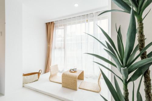 a living room with a potted plant and a table at Guan Erjie Boutique Hotel (Huimin Street of Xi'an Bell Tower ) in Xi'an