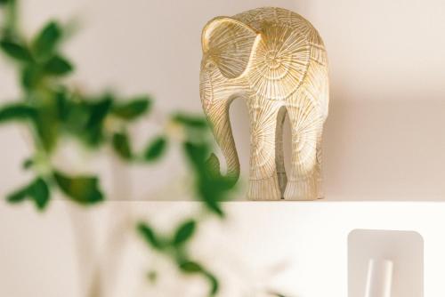 a wooden statue of an elephant sitting on a shelf at Guan Erjie Boutique Hotel (Huimin Street of Xi'an Bell Tower ) in Xi'an