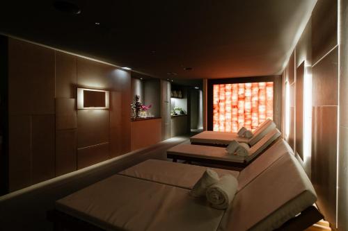 a hotel room with two beds and a window at Boscolo Nice Hotel & Spa in Nice