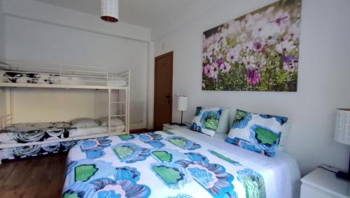 a bedroom with a bed and a painting on the wall at Visitar-Bioucas-I-AL-Q-Nature-and-Well-being-RNAL-43962-AL 