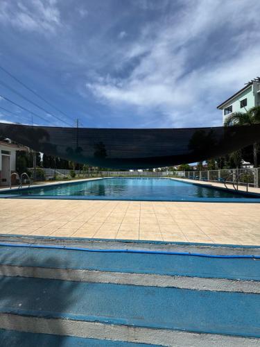 an empty swimming pool with a sky background at D88Staycations 105- Condo Staycation beside Enchanted Kingdom in Santa Rosa