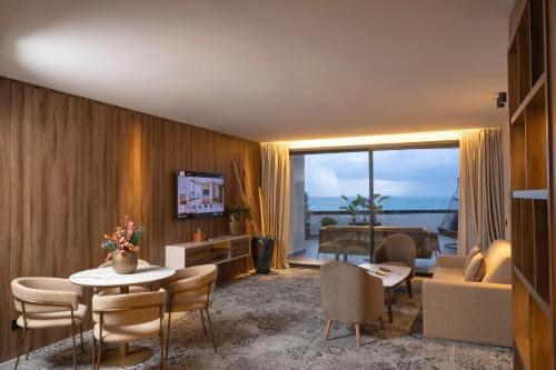 a living room with a couch and a table at Idou Malabata Beach and SPA in Tangier