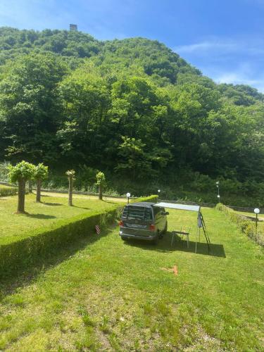 a car parked in a field with a tent at Camping BellaVista in Bolzano Novarese