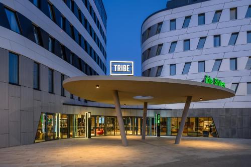 a large building with a surfboard in front of it at TRIBE Budapest Airport in Budapest