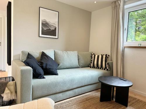 a living room with a couch and a table at 2 Wohnungen im Haus mit Sauna & Bergblick, 2 Küchen, 2 Bäder in Siegsdorf