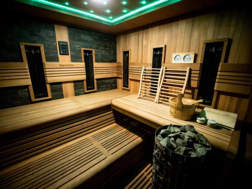 a sauna with a bench and chairs in a room at Dwór nad Bugiem w Kamieńczyku - 45 min od Warszawy in Kamieńczyk