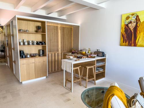 a kitchen with a table and a counter top at Noualt Suites in Ferreries