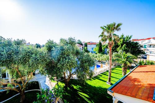 an overhead view of a park with palm trees and buildings at Resort Trcol in Novalja